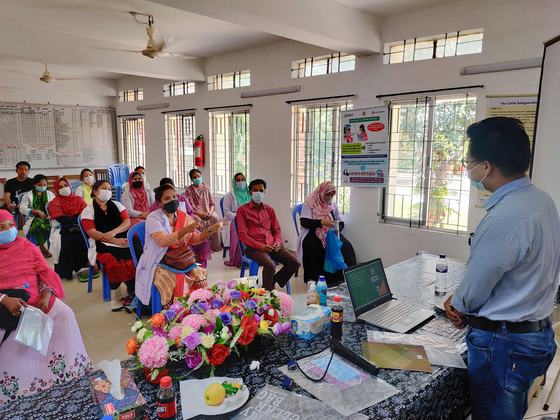 A seated participant raising a point during a training session
