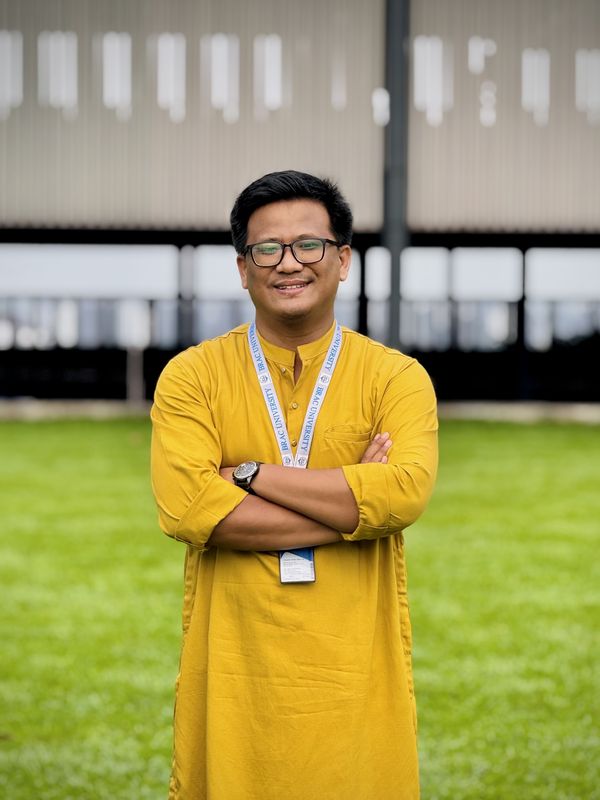 Dr. Uzzal Chandra Tangchangya standing on the lawn of the BRAC University residential campus